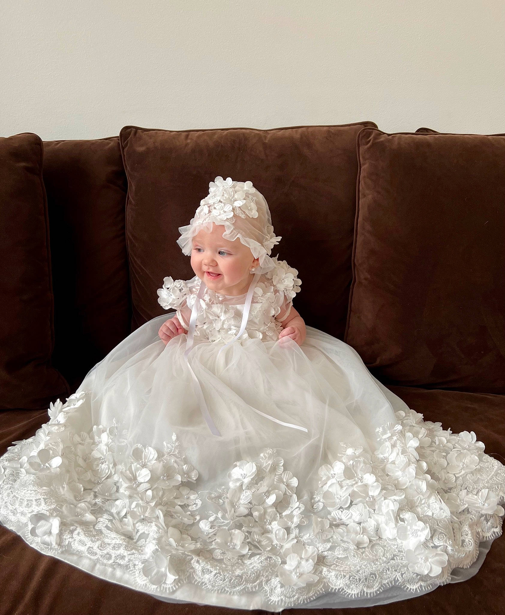 Natalie is registered to the contest to win money with this photo: bridal_accessory, bridal_clothing, bridal_party_dress, couch, day_dress, dress, embellishment, fashion_design, flooring, formal_wear, gown, head, headpiece, headwear, human_body, person, petal, sleeve, textile, toy