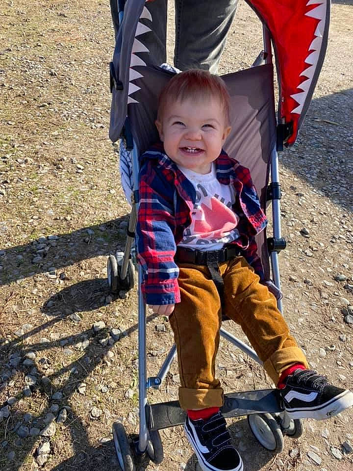 Finley is registered to the contest to win money with this photo: baby_carriage, baby_products, chair, child, comfort, electric_blue, fun, grass, joy, leg, leisure, people_in_nature, person, play, public_space, recreation, shoe, sitting, smile, sneakers