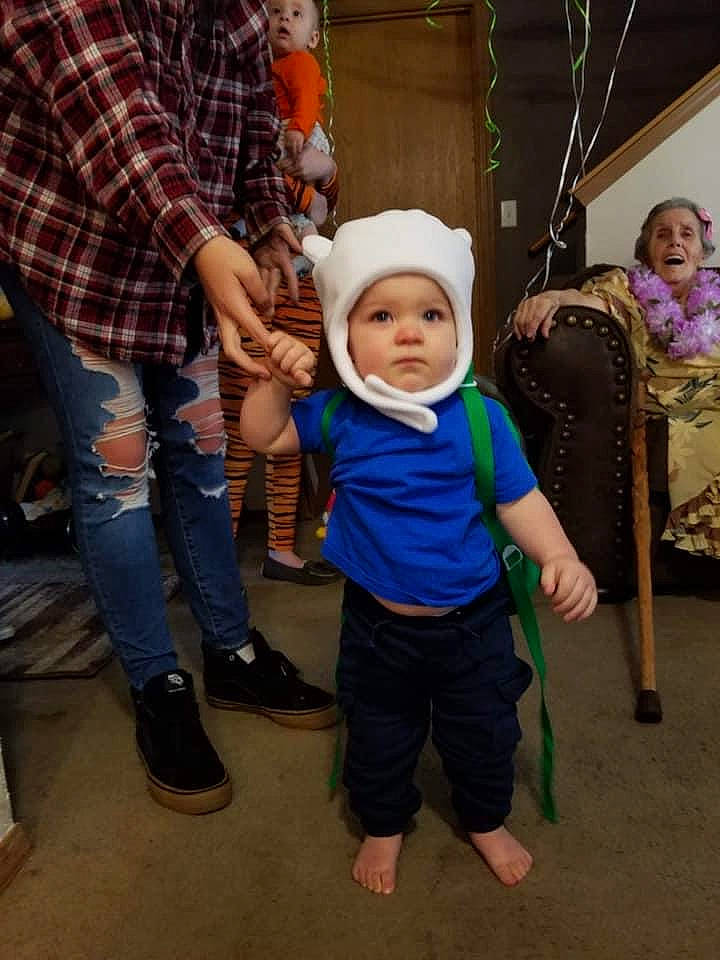 Finley is registered to the contest to win money with this photo: baby, child, costume, event, fun, happy, headwear, holiday, leg, leisure, pattern, person, plaid, play, sandal, shoe, standing, surprise, t_shirt, tartan