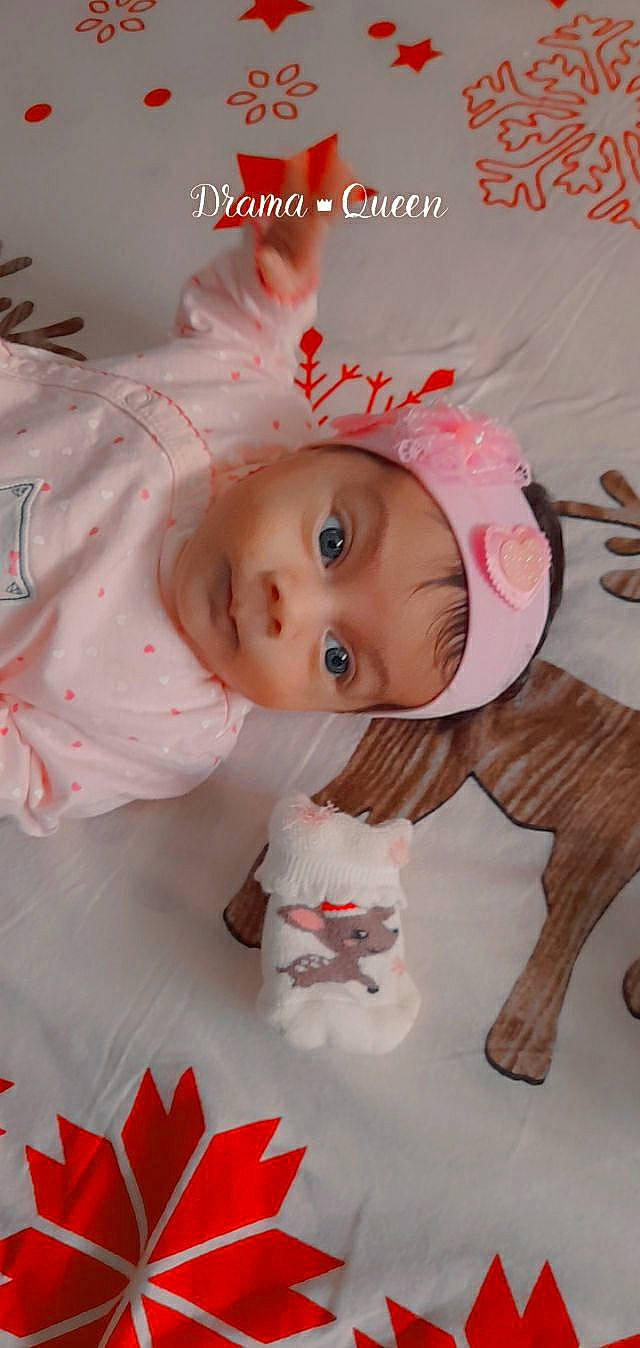 Sarah participe au concours pour gagner de l'argent avec cette photo : art, baby, baby_products, baby_toddler_clothing, baby_toys, cheek, child, dress, eyelash, happy, headpiece, linens, ornament, pattern, peach, person, petal, pink, room, skin