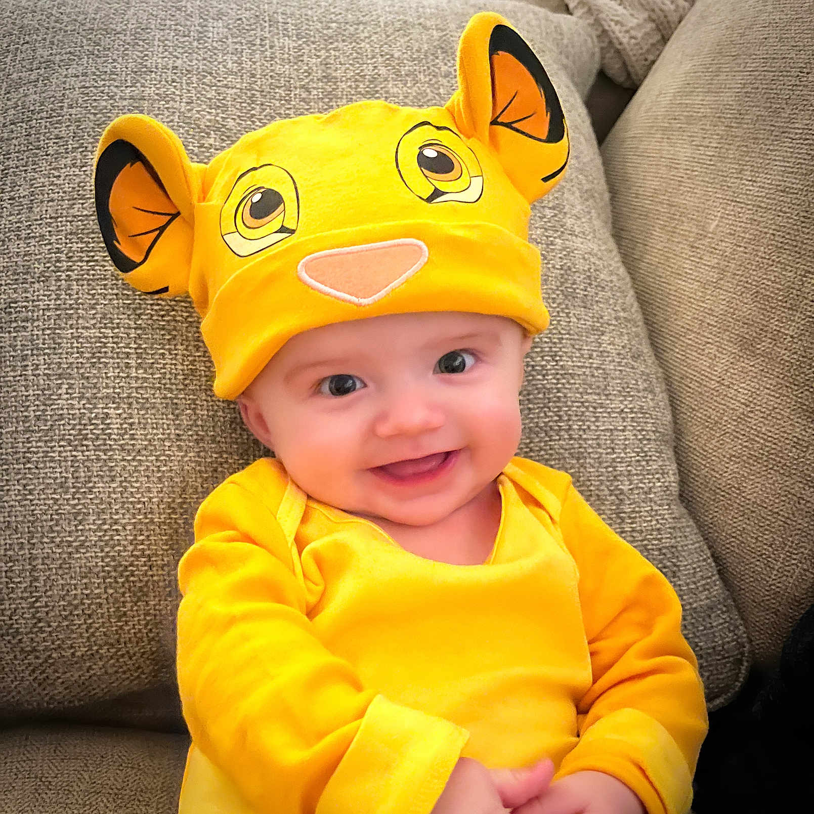 James joined the competition — help win amazing prizes! baby, beanie, bodypart, bonnet, cap, clothing, couch, cushion, face, finger, furniture, hand, happy, hat, head, homedecor, person, photography, portrait, smile