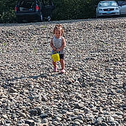 Tessa joined the competition — help win amazing prizes! car, child, daylight, girl, gravel, nature, open_car_door, outdoor, play, recreation, rocks, shoes, shorts, sleeveless_shirt, standing, summer, sunlight, trees, vehicle, yellow_bucket