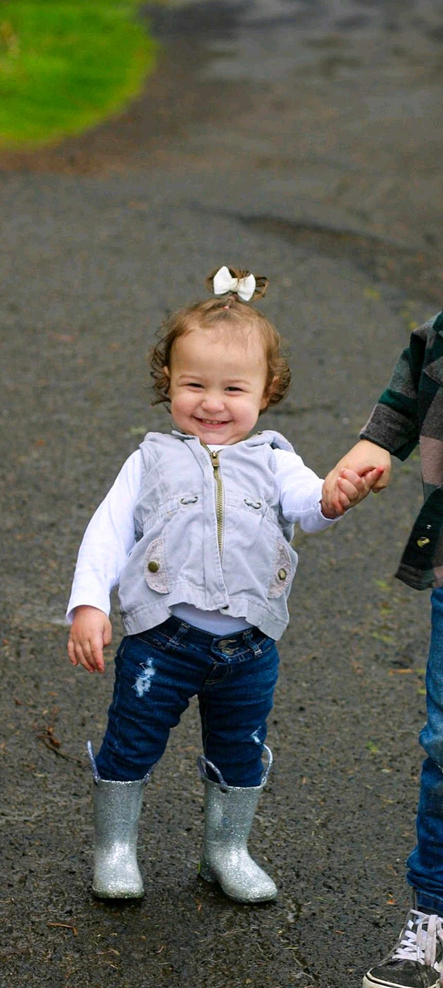 Tessa joined the competition — help win amazing prizes! boots, bow, casual, child, cute, fashion, feet, fun, happy, holding_hands, jeans, outdoor, pavement, person, playful, sibling, smiling, toddler, vest, walking
