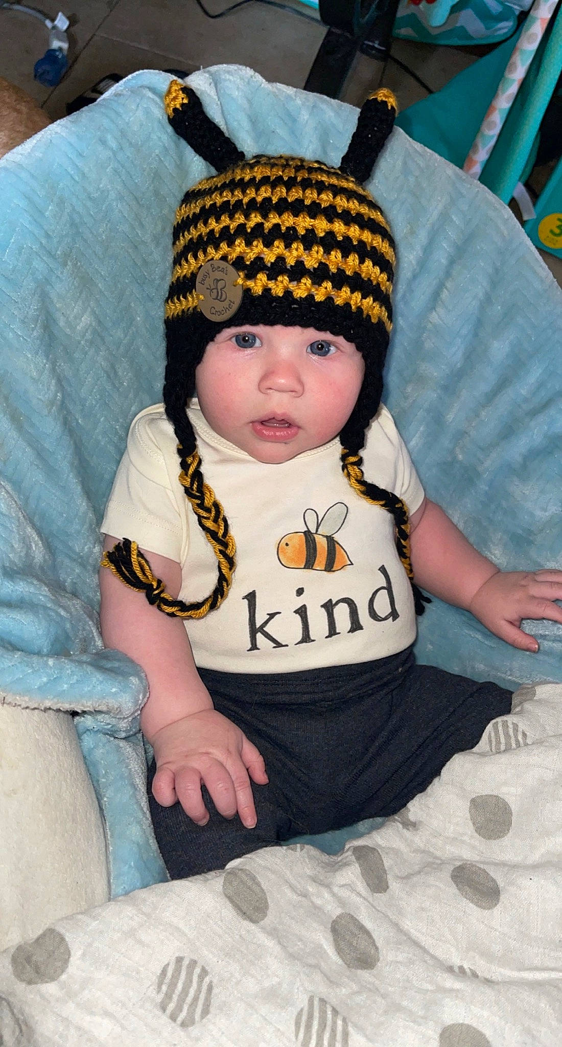 Charley is registered to the contest to win money with this photo: baby, baby_toddler_clothing, beanie, cap, cheek, child, comfort, costume_hat, eye, fashion_accessory, headgear, headwear, knit_cap, pattern, person, sitting, skin, sleeve, textile, toddler