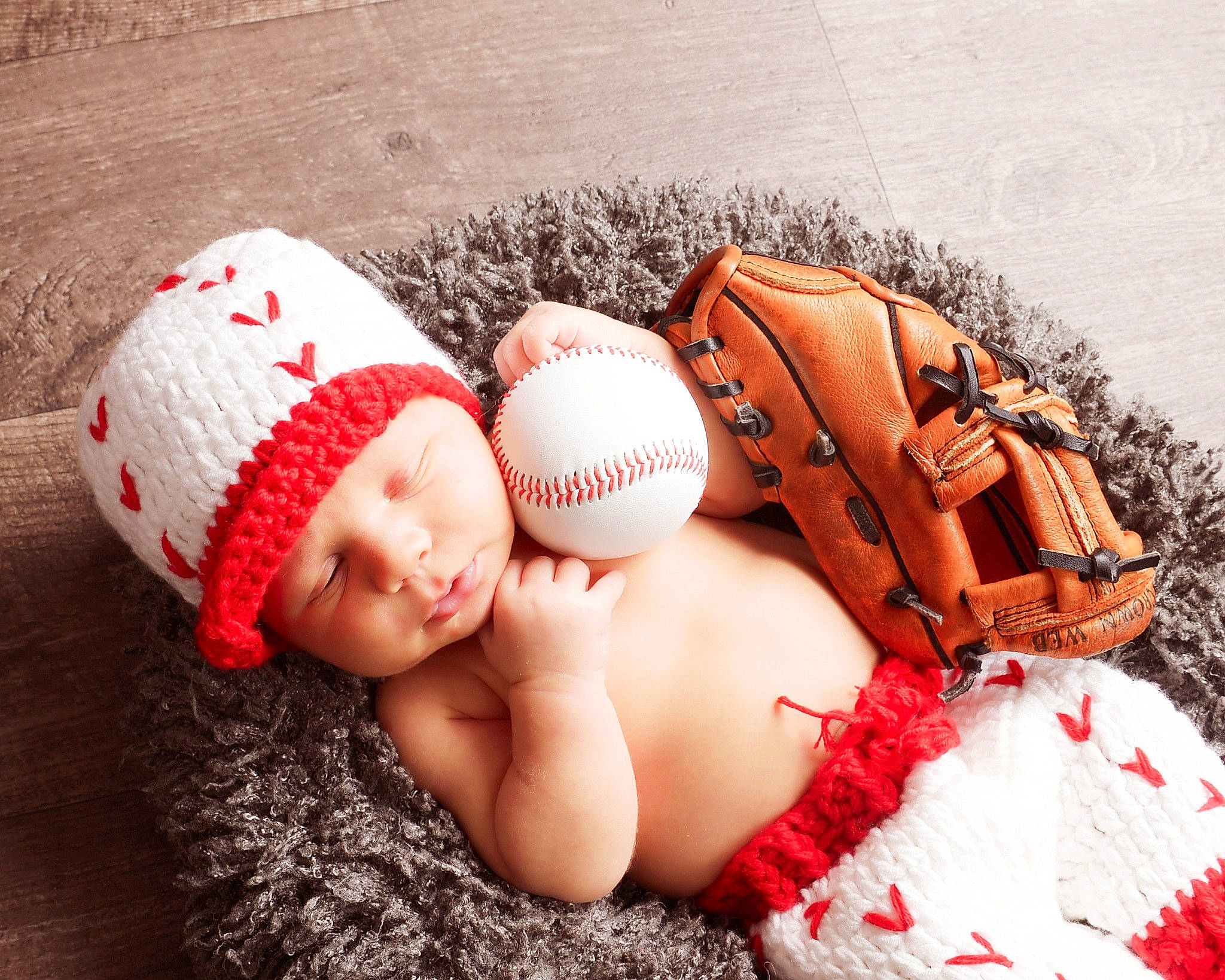 Gunner is registered to the contest to win money with this photo: baby, baby_sleeping, baby_toddler_clothing, baseball, cap, comfort, finger, flash_photography, grass, hand, happy, headgear, headwear, knit_cap, pattern, person, personal_protective_equipment, skin, textile, toddler