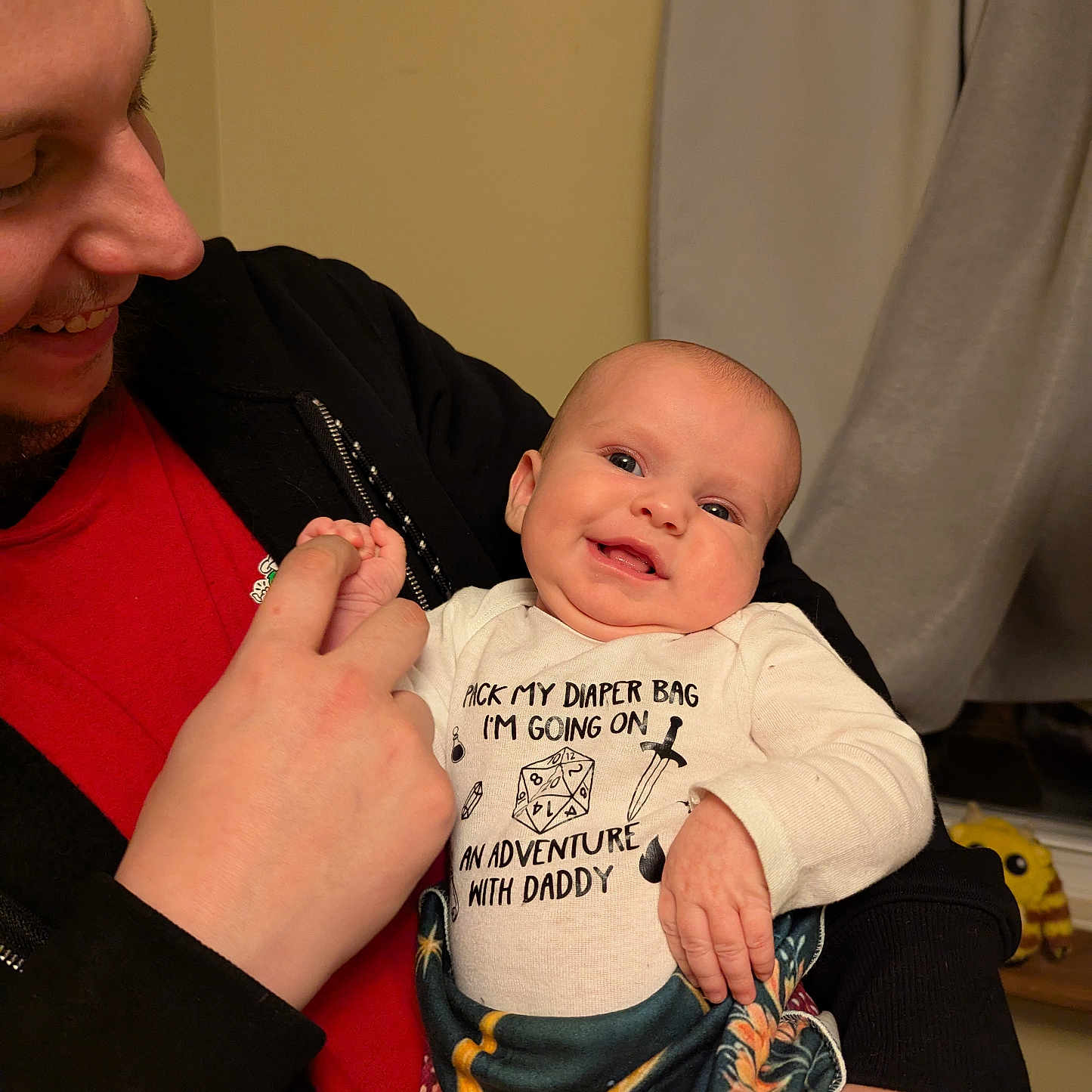 Kyra is registered to the contest to win money with this photo: accessories, baby, bodypart, clothing, couch, face, finger, furniture, glove, hand, head, knitwear, newborn, pants, person, photography, portrait, sitting, sweater, t_shirt