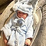 baby, infant, robe, elephant_hood, blue, plush, soft, cute, comfortable, seated, indoor, face, skin, hand, foot, blanket, child, young, baby_seat, clothing