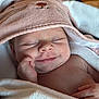 baby, smiling, towel, hood, pink, white, face, skin, hand, sleeping, cute, newborn, infant, soft, cozy, portrait, wrapped, peaceful, indoors, closeup
