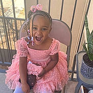 Levina joined the competition — help win amazing prizes! child, girl, pink_dress, braided_hair, beads, doll, chair, smiling, happy, outdoor, balcony, plant, pot, railing, white_tights, concrete_floor, sunlight, portrait, cute, joyful