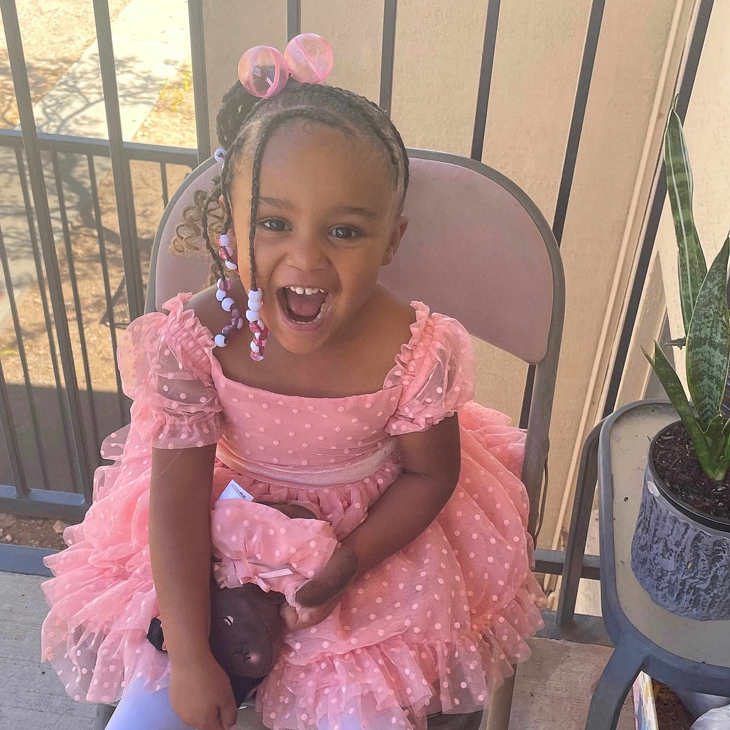 Levina joined the competition — help win amazing prizes! balcony, beads, braided_hair, chair, child, concrete_floor, cute, doll, girl, happy, joyful, outdoor, pink_dress, plant, portrait, pot, railing, smiling, sunlight, white_tights