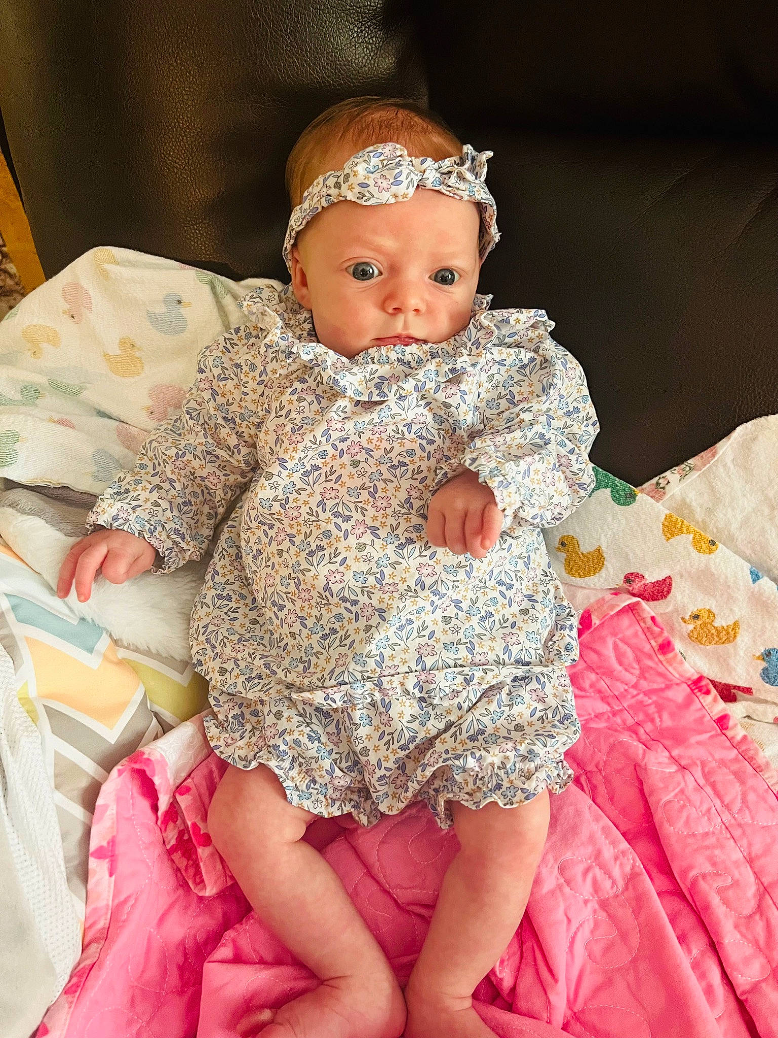 Emilia is registered to the contest to win money with this photo: baby, baby_toddler_clothing, chair, child, dress, embellishment, event, eye, fashion, fashion_design, happy, headpiece, headwear, human_body, jewellery, peach, person, pink, sitting, skin