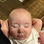 baby, sleeping, peaceful, face, arms, indoor, wooden_floor, closeup, chubby_cheeks, long_eyelashes, infant, person, cute, relaxed, white_clothing, head, skin, child, portrait, resting