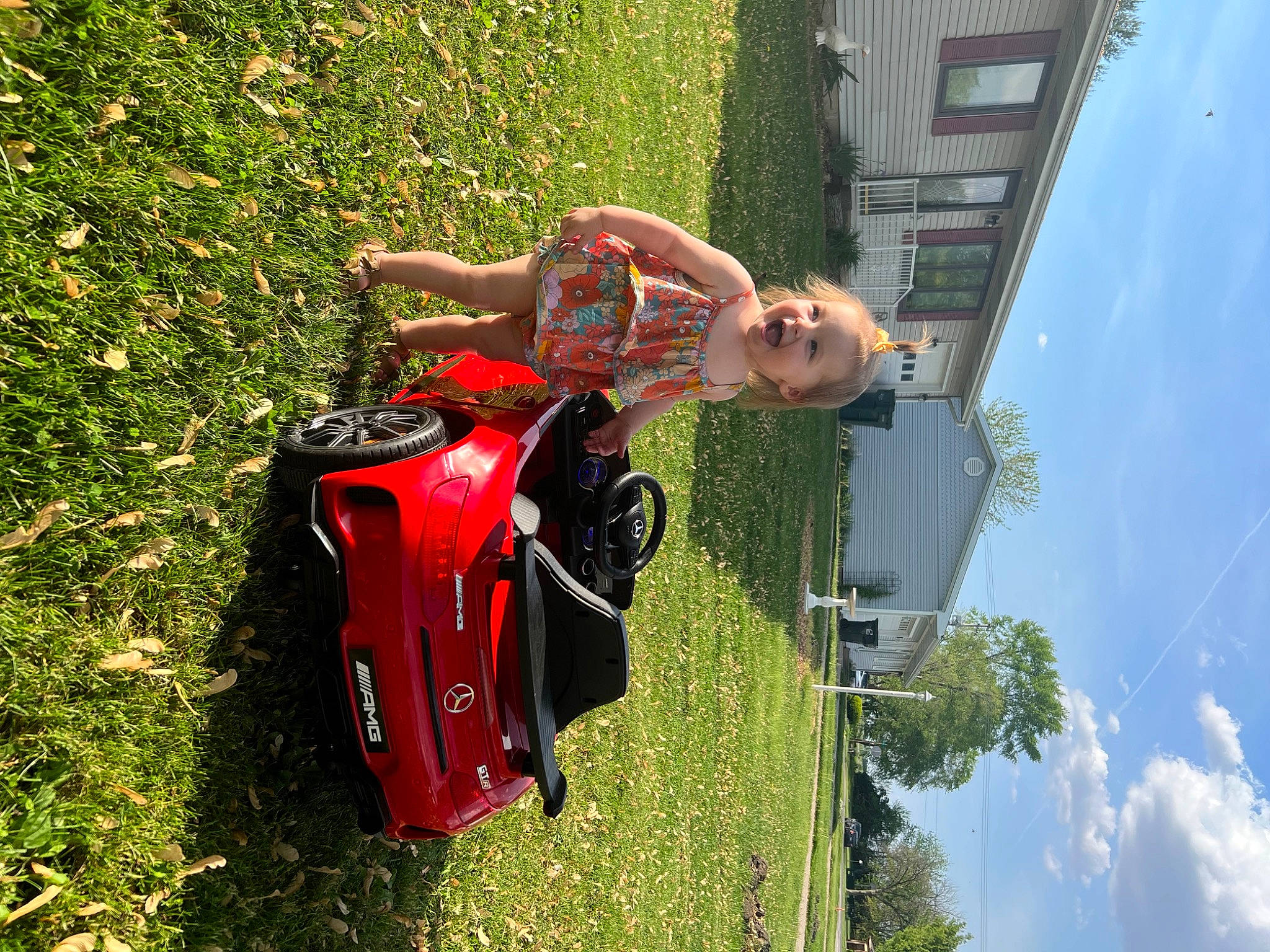 Bryar joined the competition — help win amazing prizes! automotive_exterior, automotive_lighting, baby, building, car, cloud, fun, grass, green, leisure, motor_vehicle, person, plant, recreation, sky, smile, tire, toddler, tree, vehicle