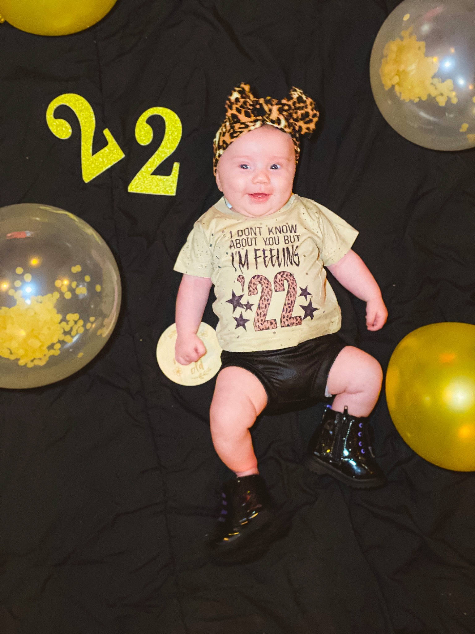 Novah is registered to the contest to win money with this photo: astronomical_object, baby_toddler_clothing, balloon, child, circle, event, flash_photography, font, fun, happy, headwear, light, lighting, party_supply, person, shorts, sleeve, smile, t_shirt, thigh