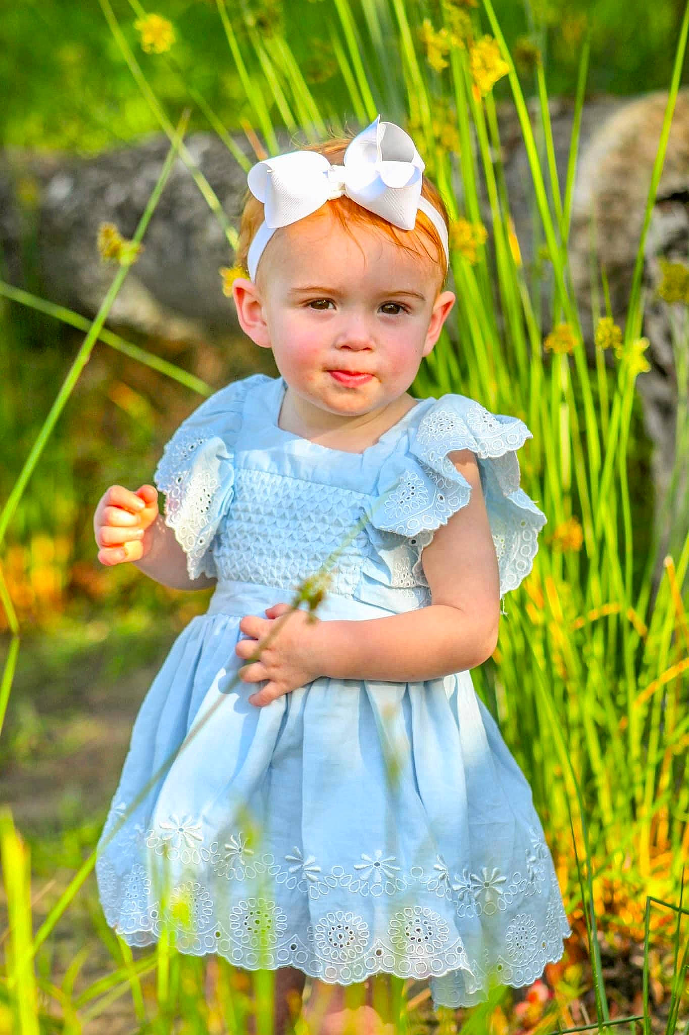 Taylor is registered to the contest to win money with this photo: baby, baby_toddler_clothing, botany, child, dress, eye, grass, grass_family, grassland, happy, meadow, pattern, people_in_nature, person, plant, skin, sleeve, smile, summer, sunlight