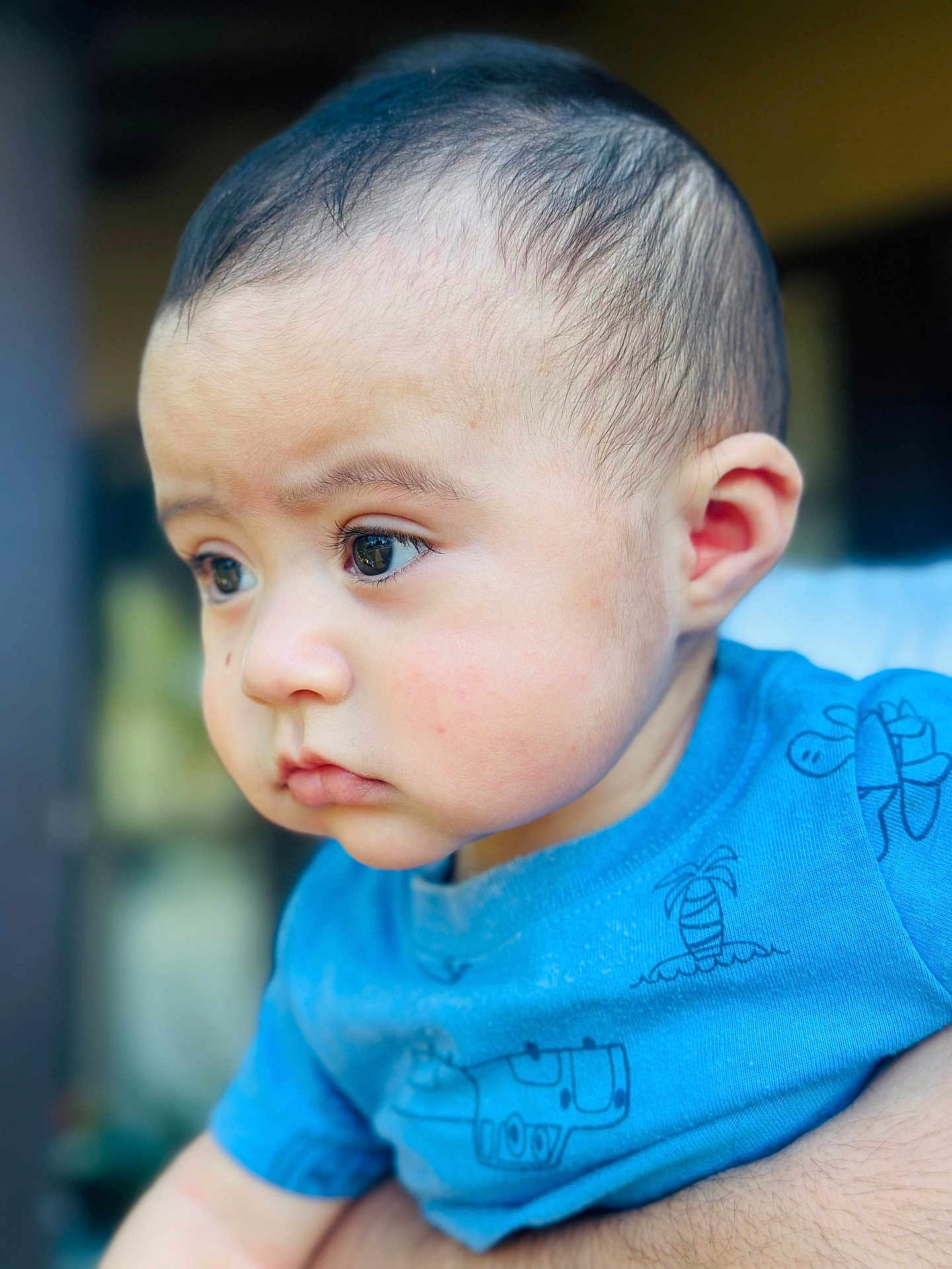 Gabriel joined the competition — help win amazing prizes! baby, child, closeup, face, blue_shirt, expression, innocence, curious, portrait, person, skin, hair, eyelashes, cheeks, hand, clothing, young, cute, indoors, focus