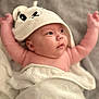 baby, infant, towel, white_towel, hooded_towel, arms_up, cute, soft_texture, indoor, blanket, skin, child, portrait, expression, newborn, lying_down, headwear, smile, chubby_cheeks, wrapped