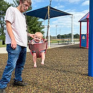 Willow joined the competition — help win amazing prizes! baby, child, clouds, daylight, footwear, fun, happy, holding, jeans, outdoor, park, person, play_equipment, playground, sky, smile, swing, trees, tshirt, young_man