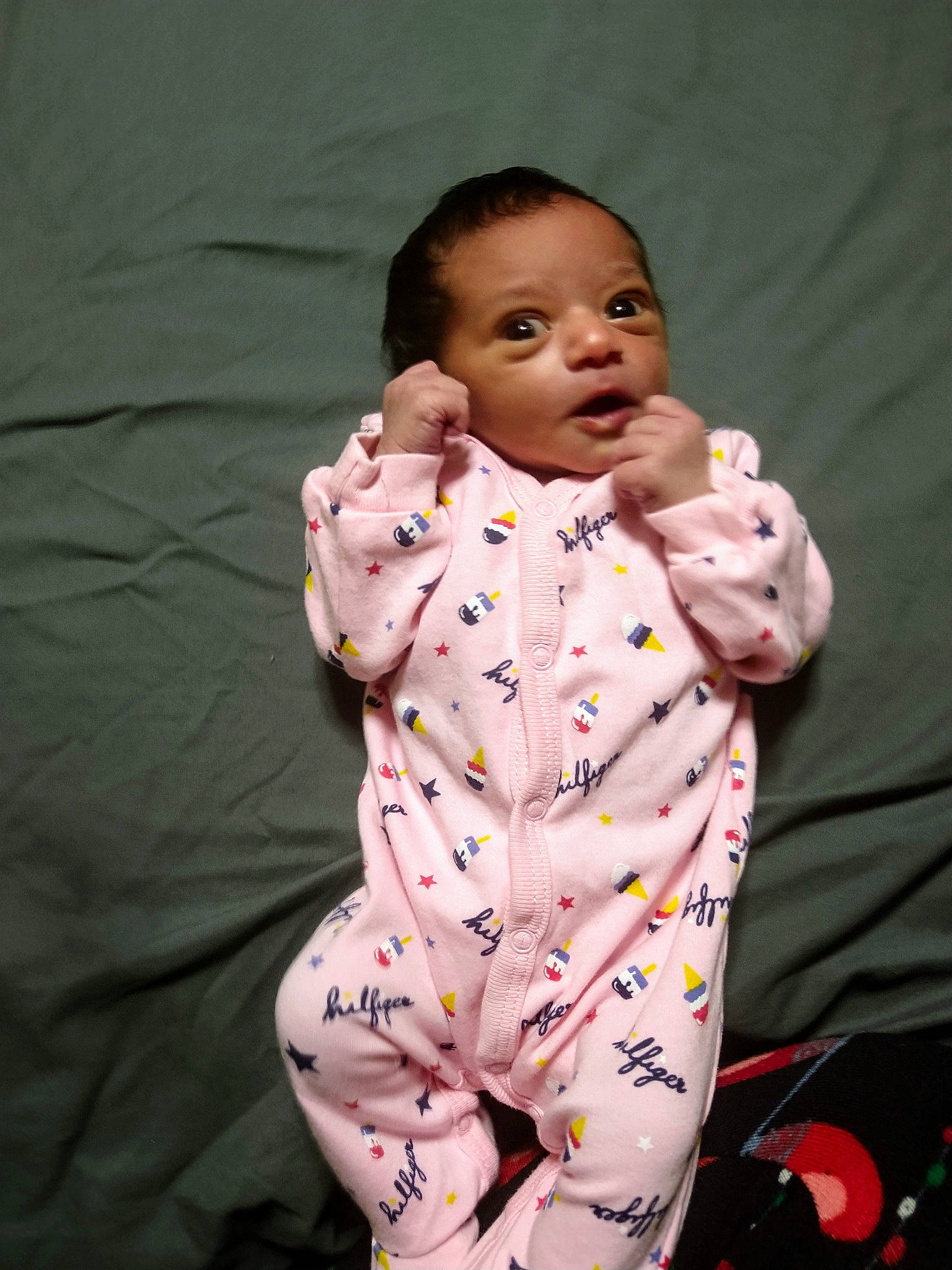 Aisha is registered to the contest to win money with this photo: baby, cheek, child, eye, lip, pajamas, person, pink, skin, smile, toddler