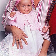 Morgan joined the competition — help win amazing prizes! baby, child, infant, pink_dress, headband, smile, adult_hand, striped_shirt, portrait, indoor, cute, holding, seated, happy, female, person, family, closeup, fashion, accessory