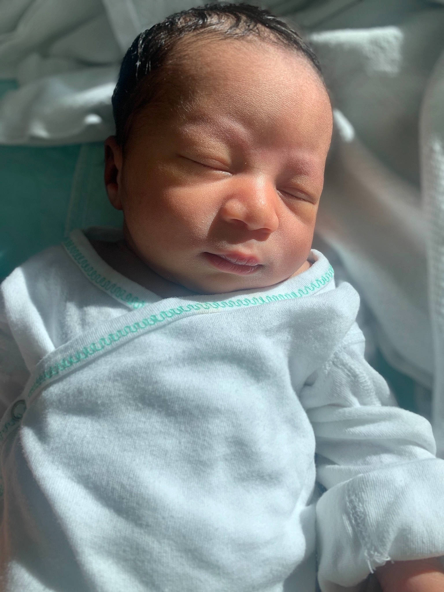 Zamari is registered to the contest to win money with this photo: baby, baby_toddler_clothing, cheek, child, childbirth, comfort, facial_expression, linens, mouth, person, room, skin, sleeve, thumb, toddler, wrinkle