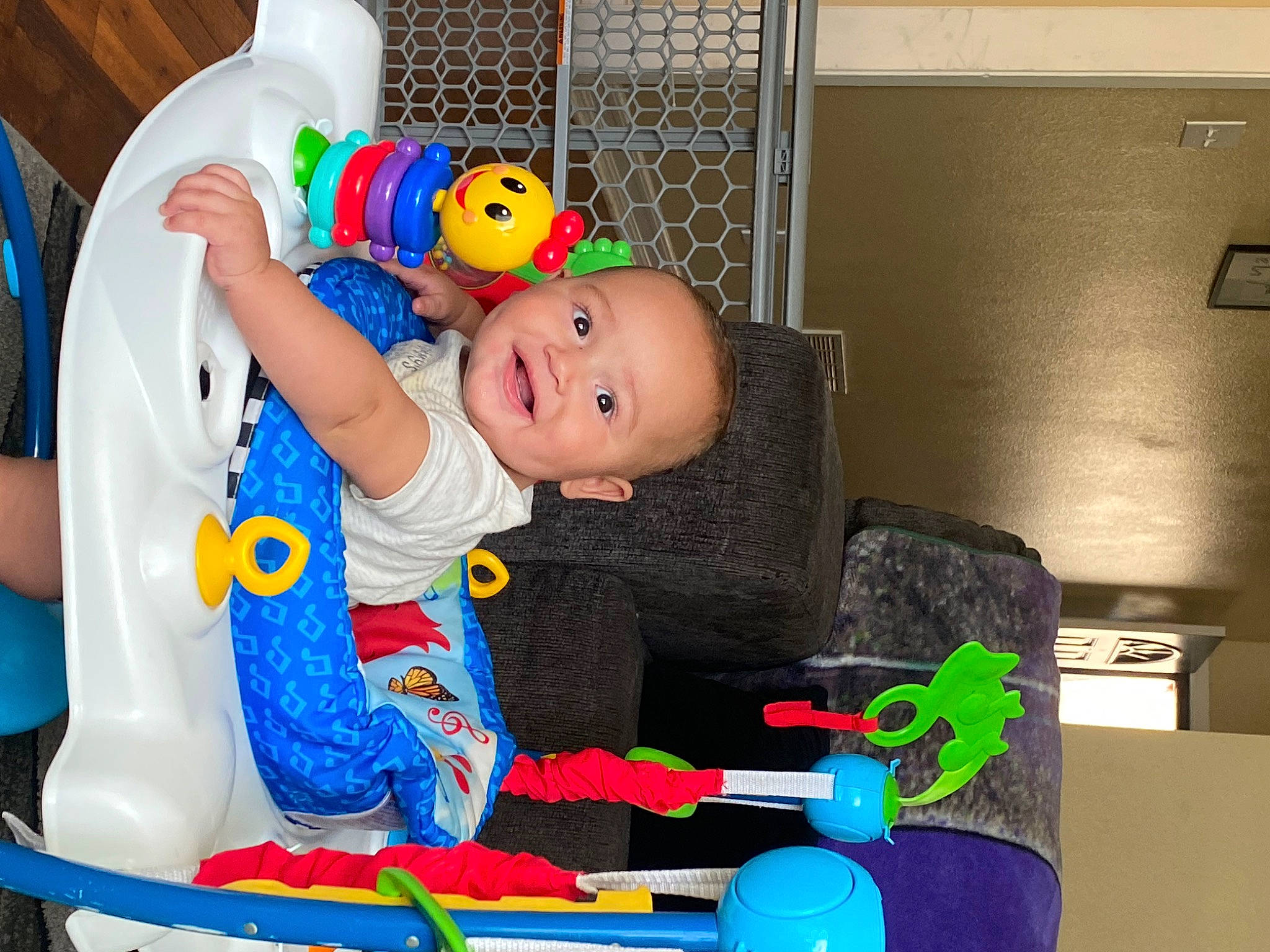 Ezra joined the competition — help win amazing prizes! baby, baby_playing_with_toys, baby_products, baby_safety, baby_toddler_clothing, baby_toys, blue, chair, child, event, fun, happy, joy, person, plastic, play, product, room, sitting, smile
