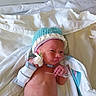 Noah is registered to the contest to win money with this photo: newborn, baby, infant, hospital, bed, blanket, hat, medical_band, sensor, skin, person, lying_down, cute, small, healthcare, child, wrapped, hospital_bed, monitoring, resting