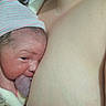 Noah is registered to the contest to win money with this photo: newborn, baby, hospital, hat, skin, parent, wristband, blanket, closeup, face, infant, hospital_gown, human, headwear, skin_to_skin, birth, medical, fresh, hospital_room, rest