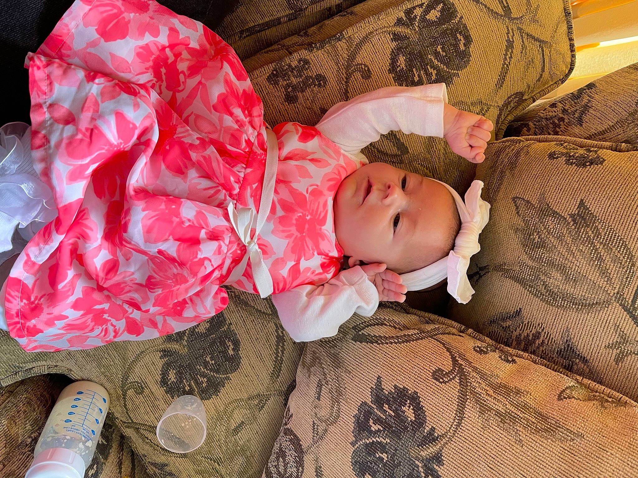 Saphina is registered to the contest to win money with this photo: baby, baby_toddler_clothing, bedding, carmine, cheek, comfort, couch, doll, flooring, head, lap, linens, pattern, person, pink, sitting, skin, sleeve, toddler, tree