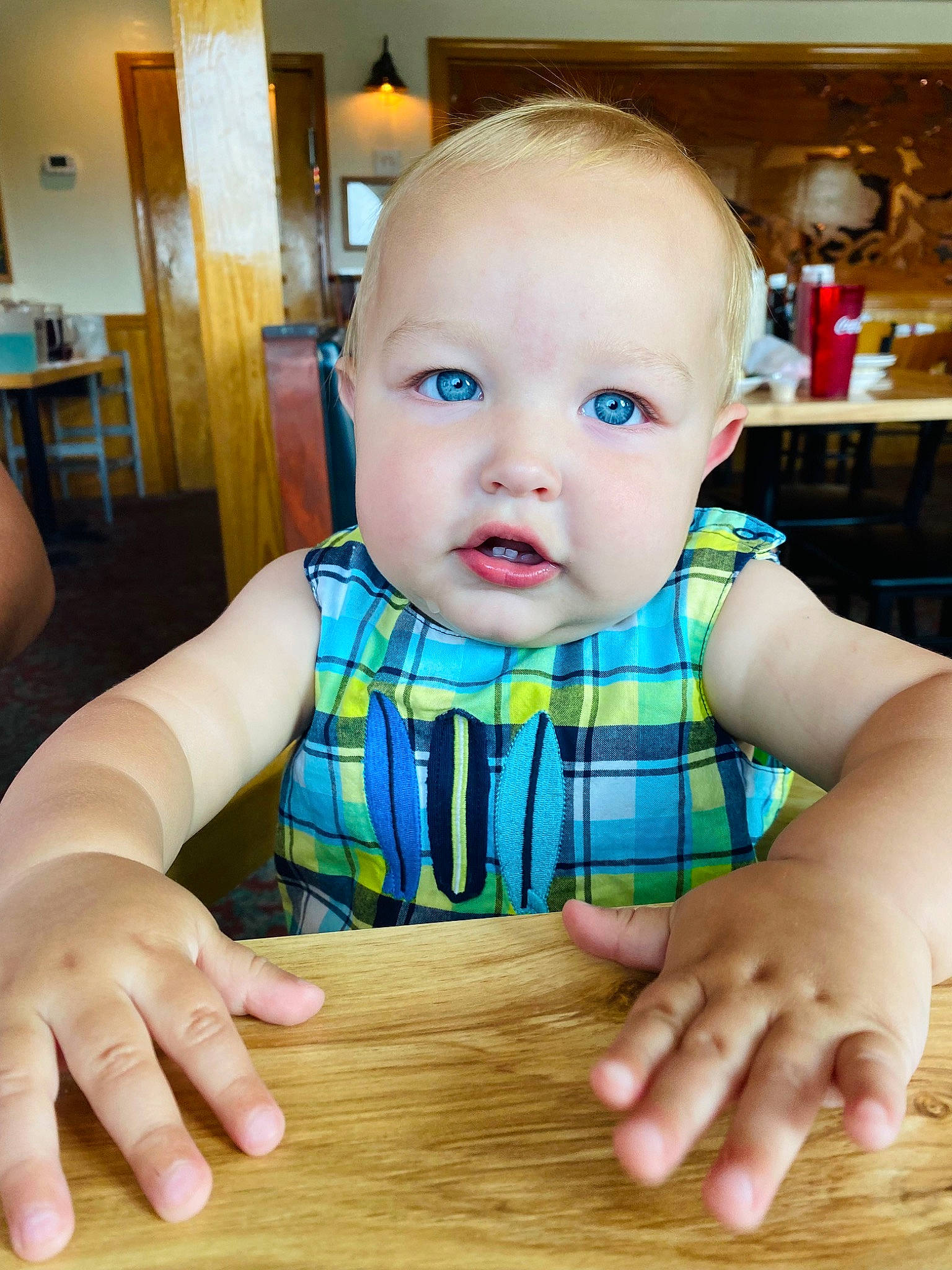 Beckham is registered to the contest to win money with this photo: baby, baby_toddler_clothing, chair, cheek, child, finger, flooring, fun, hand, hardwood, nail, person, sitting, skin, table, thumb, toddler, varnish, wood, wood_stain