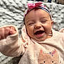 apparel, baby, blanket, cat_embroidery, child, closeup, cozy_clothing, cute, face, happy, headband, indoors, infant, joyful, laughing, pink_bow, portrait, smiling, soft_texture, toddler