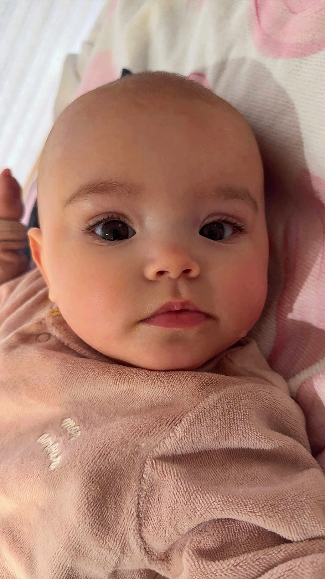 Gabriella participe au concours pour gagner de l'argent avec cette photo : baby, close_up, face, eyes, pink_clothing, blanket, infant, child, soft_texture, cute, portrait, young, skin, expression, lying_down, indoors, head, chubby_cheeks, newborn, adorable