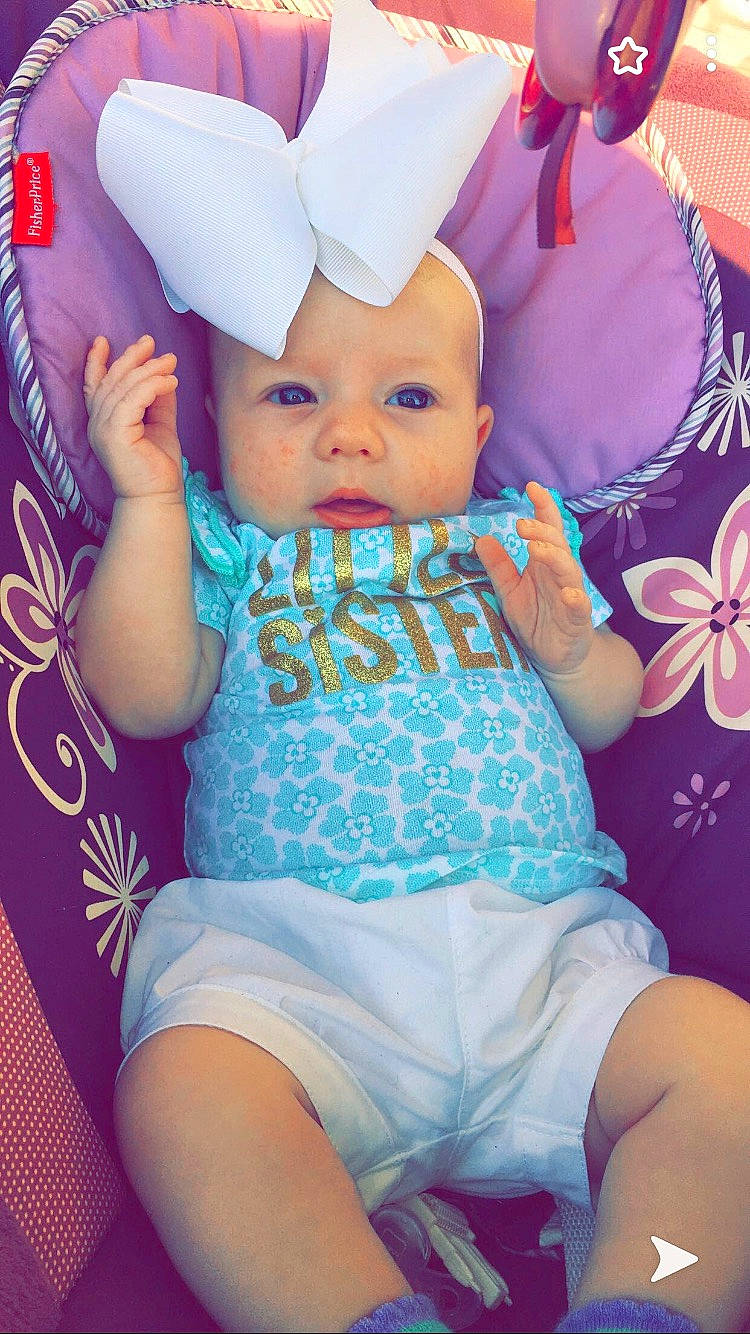 Leiana is registered to the contest to win money with this photo: arm, azure, baby, baby_toddler_clothing, clothing, cool, facial_expression, finger, hand, happy, hat, headgear, headwear, human_body, mouth, person, pink, purple, skin, t_shirt