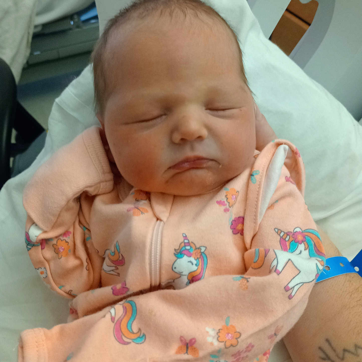Esther Leeann Taylor is registered to the contest to win money with this photo: baby, blanket, child, cozy, cute, hand, hospital, indoors, infant, newborn, peaceful, person, pink_clothing, portrait, resting, sleeping, soft, tattoo, unicorn_pattern, wristband