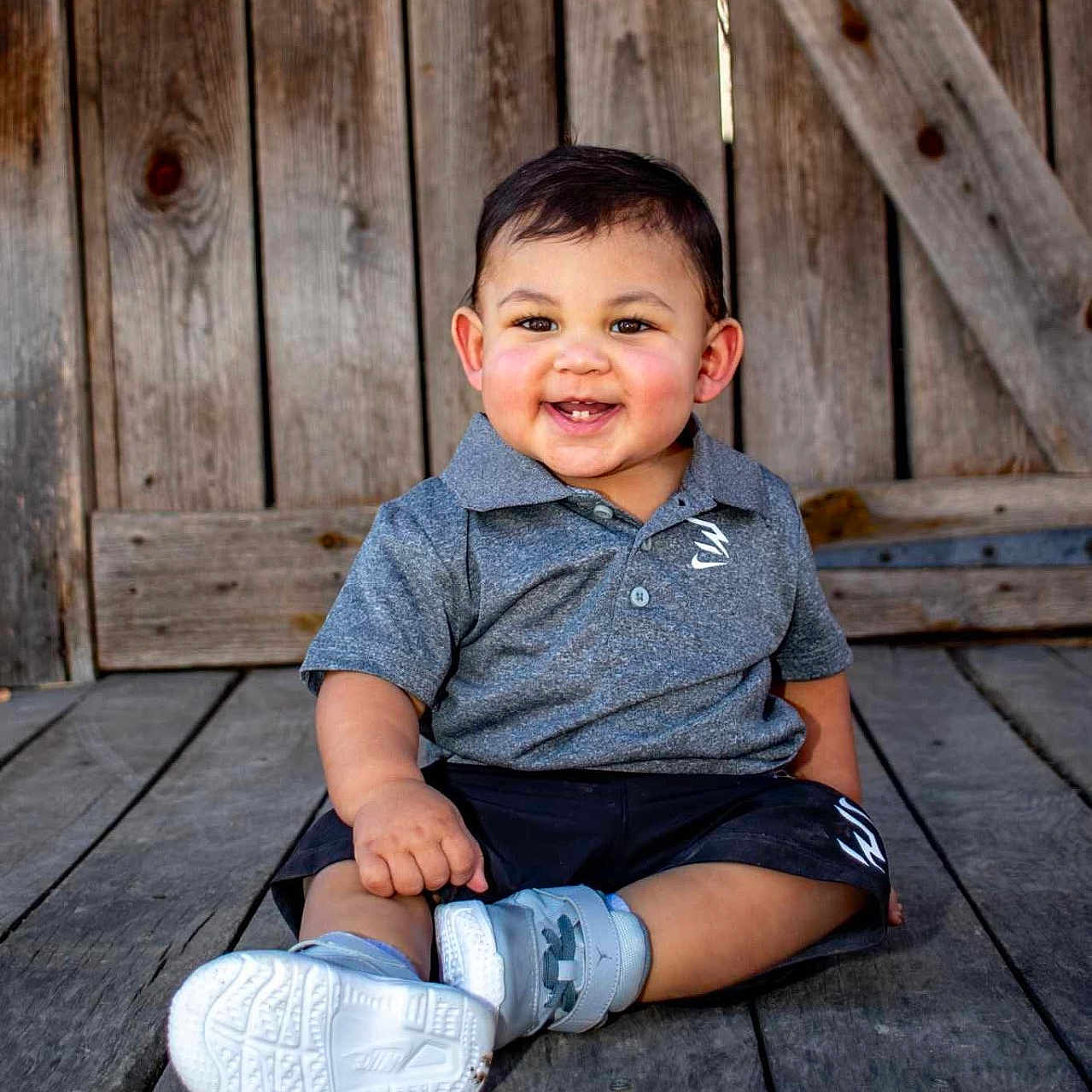 Mikeal joined the competition — help win amazing prizes! boy, child, clothing, face, footwear, happy, head, jeans, male, pants, person, photography, portrait, shoe, shorts, sitting, sleeve, smile, sneaker, wood