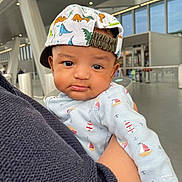 Osamu joined the competition — help win amazing prizes! arm, baby, blue_outfit, cap, child, closeup, clothing, curious_expression, cute, dinosaur_print, face, headwear, holding, indoor, infant, modern_building, person, portrait, sailboat_print, window