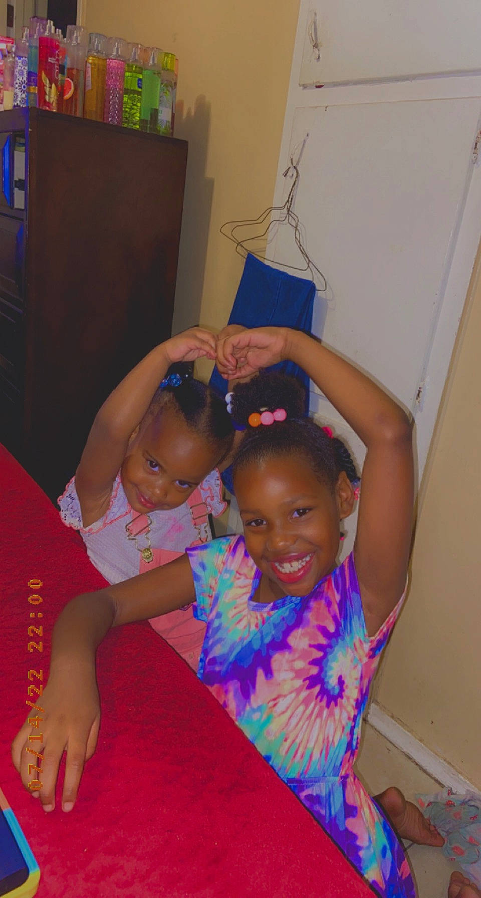 Keymora And Kamara is registered to the contest to win money with this photo: abdomen, barefoot, child, event, finger, flooring, foot, fun, gesture, happy, human_leg, joy, leisure, magenta, person, pink, room, smile, t_shirt, thigh