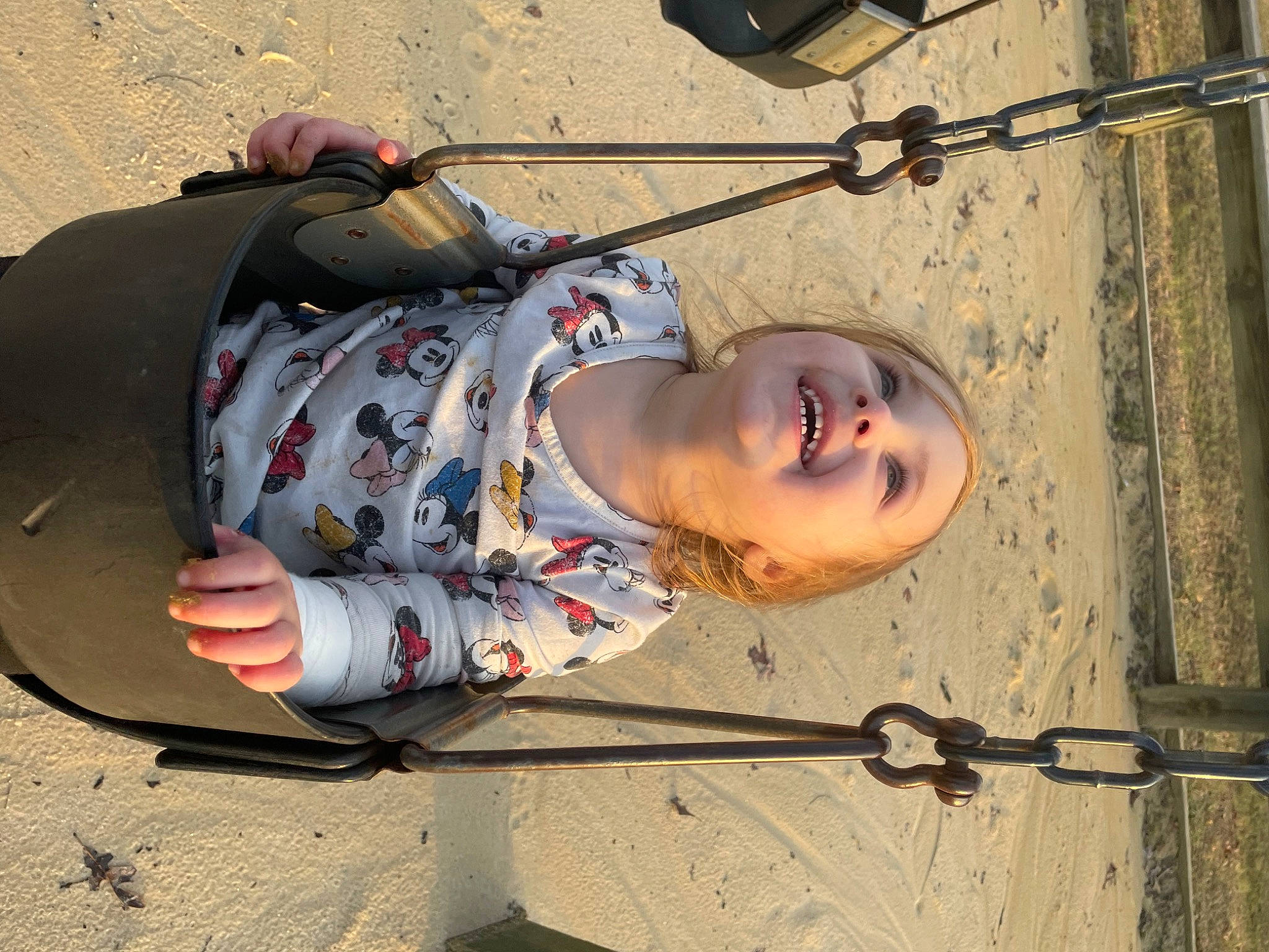 Cady Mae is registered to the contest to win money with this photo: eyewear, fashion_accessory, fun, joy, landscape, leisure, person, personal_protective_equipment, sand, shadow, sitting, smile, toddler, tree, wire, wood