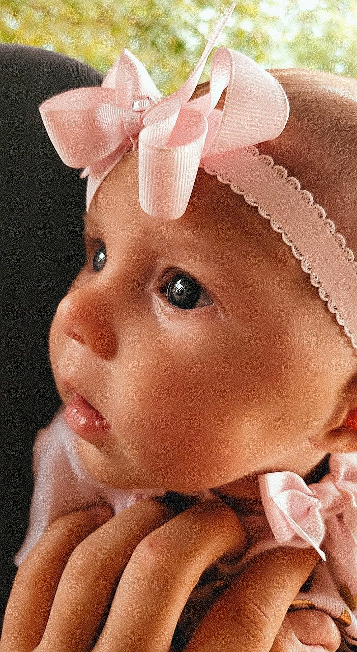 Cady is registered to the contest to win money with this photo: baby, cheek, child, ear, eyelash, face, fashion_accessory, forehead, hair_accessory, head, headband, headgear, headpiece, headwear, lip, nose, organ, person, pink, skin