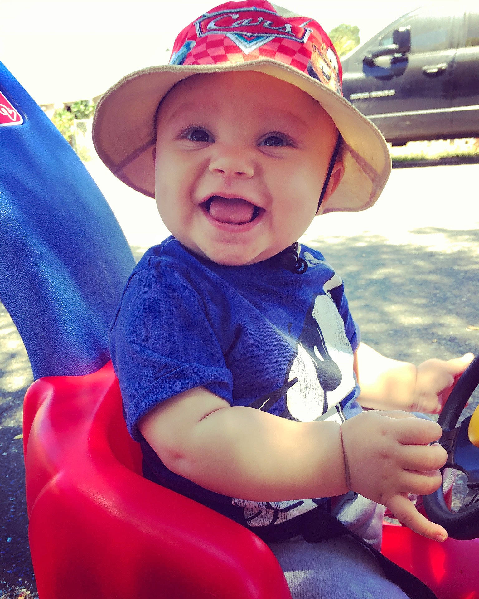 Cristiano is registered to the contest to win money with this photo: baby_carriage, baby_products, blue, cap, child, cool, day, fun, happiness, headgear, headwear, infant, person, play, product, red, sitting, skin, smile, toddler