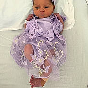 Kinsley joined the competition — help win amazing prizes! newborn, baby, infant, purple_dress, headband, blanket, lying_down, cute, small_feet, baby_clothing, floral_embroidery, bandage, hospital_band, indoors, portrait, resting, baby_face, soft_light, peaceful, adorable