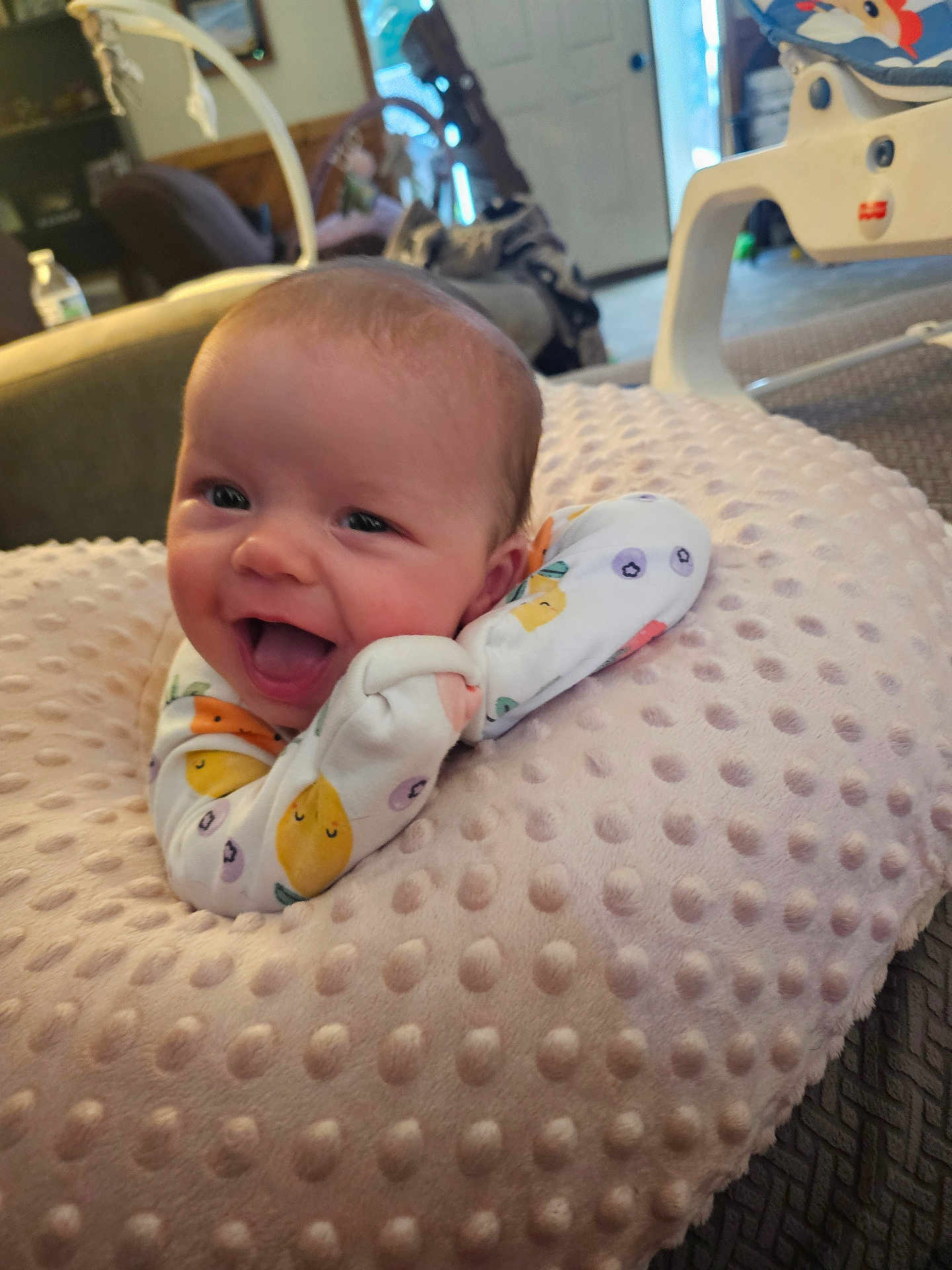 Rimantė is registered to the contest to win money with this photo: baby, child, comfort, couch, cozy, cute, face, fruit_pattern, furniture, happy, head, indoor, infant, onesie, person, pillow, relaxation, smiling, soft_texture, young