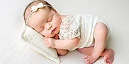 Rimantė is registered to the contest to win money with this photo: baby, newborn, sleeping, infant, white, lace, headband, pillow, blanket, soft, peaceful, cute, resting, toddler, skin, hand, foot, closeup, portrait, child