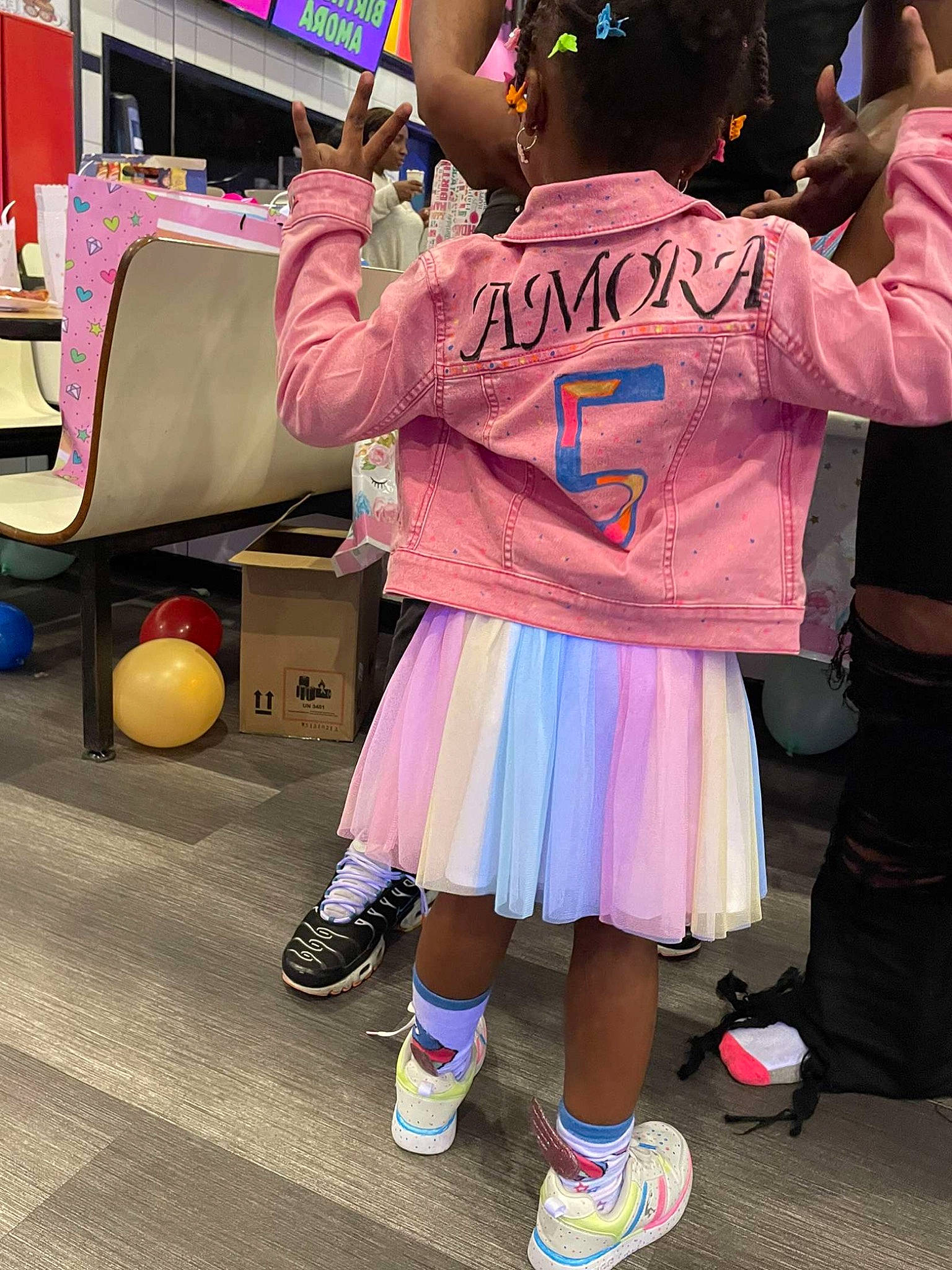 Amora is registered to the contest to win money with this photo: bag, child, event, footwear, fun, human_leg, leisure, luggage_and_bags, people, person, photograph, pink, purple, recreation, shoe, snapshot, sneakers, sock, t_shirt, thigh