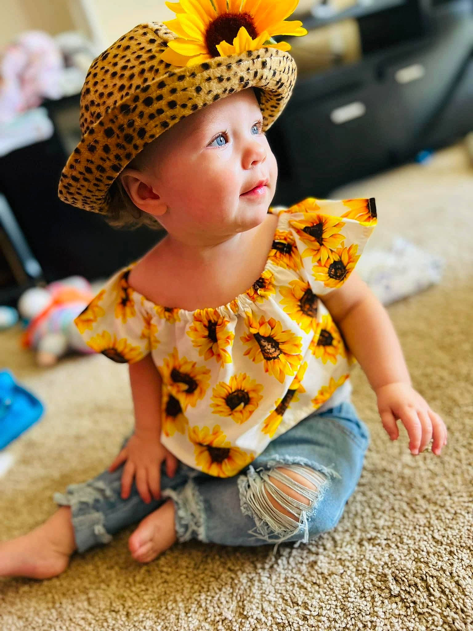 Brayleigh joined the competition — help win amazing prizes! baby, baby_toddler_clothing, cap, child, costume_hat, eye, fashion_accessory, fun, grass, happy, headgear, headwear, leisure, orange, person, sitting, sleeve, t_shirt, tire, toddler