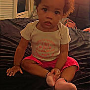 Katelyn joined the competition — help win amazing prizes! backpack, bed, bedroom, blanket, child, curly_hair, cute, dark_bedspread, hands, indoor, onesie, pink_shorts, portrait, shutters, sitting, socks, toddler, tv_screen, wide_eyes, window