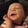 Bryson is registered to the contest to win money with this photo: baby, infant, face, hand, striped_shirt, orange, white, cute, expression, indoor, portrait, child, skin, person, smiling, newborn, closeup, cozy, resting, casual