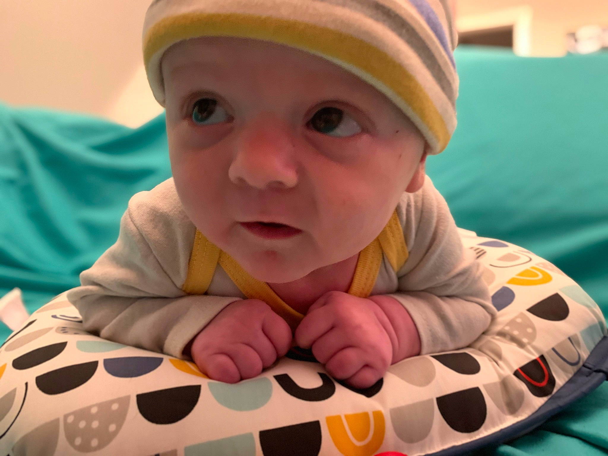 Konnor is registered to the contest to win money with this photo: baby, baby_toddler_clothing, cap, cheek, child, comfort, eye, finger, flooring, happy, headwear, linens, mouth, nose, person, pink, skin, sleeve, thumb, toddler