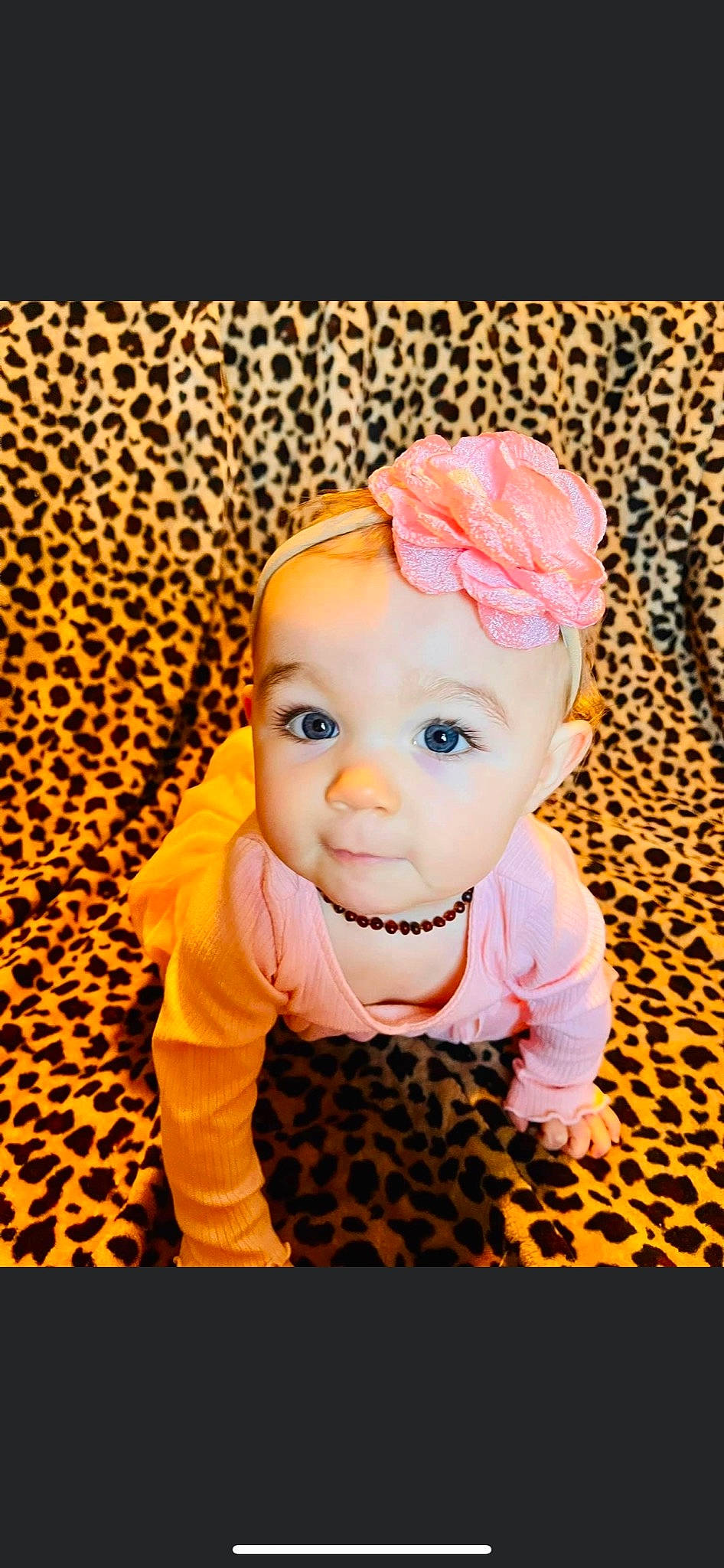Ophelia is registered to the contest to win money with this photo: baby, baby_toddler_clothing, cheek, child, costume_hat, eye, fashion_accessory, flooring, happy, head, headwear, magenta, pattern, peach, person, portrait_photography, sitting, skin, sleeve, smile