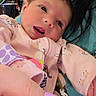 Alayna is registered to the contest to win money with this photo: baby, cozy, cute, face, furniture, hand, holding, home, indoor, infant, lamp, nail_polish, newborn, onesie, pacifier_clip, person, pink_clothing, portrait, skin, sleepwear